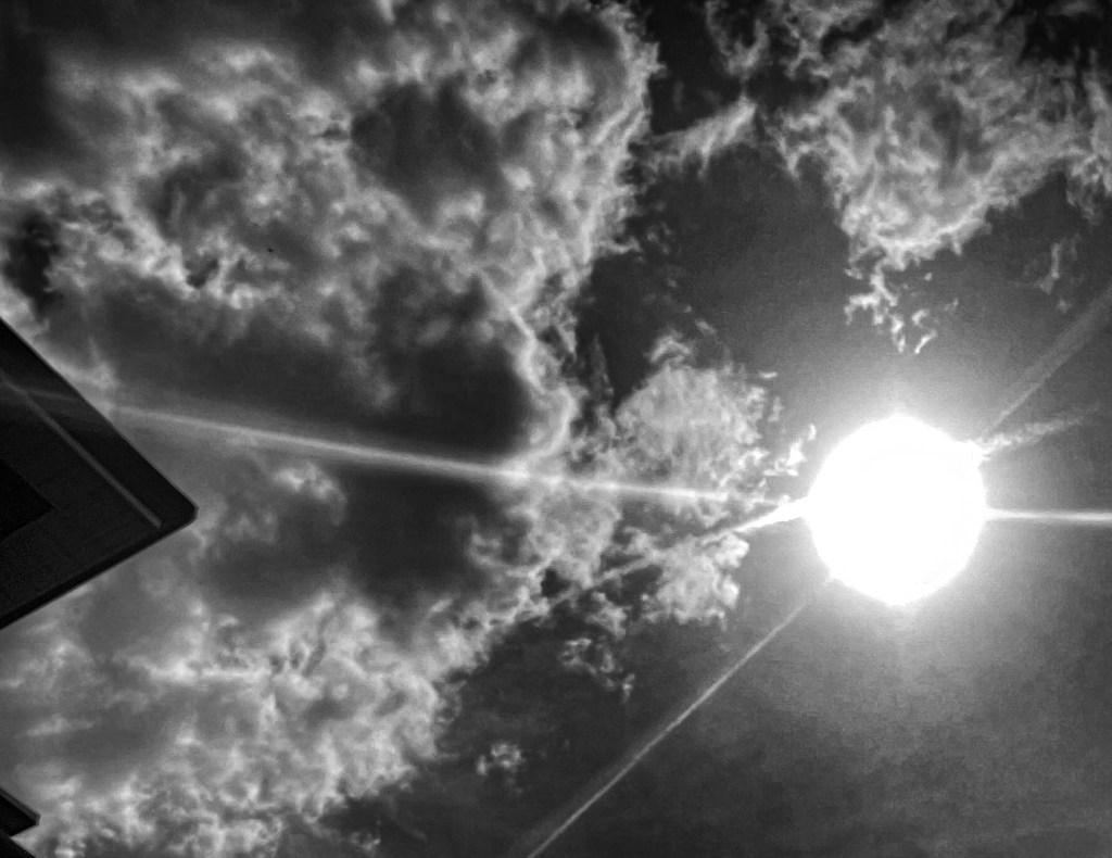 sun and clouds in black and white